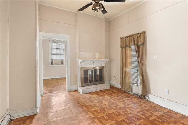 unfurnished living room featuring crown molding, parquet flooring, and ceiling fan