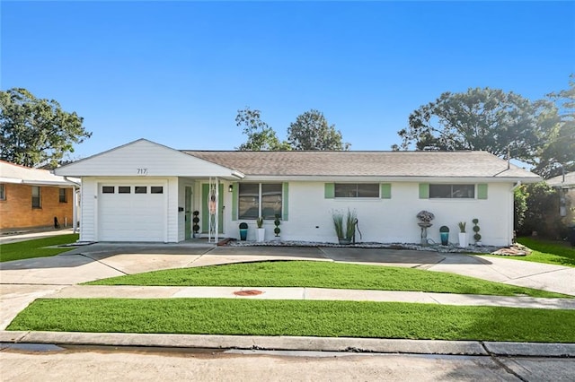 single story home featuring a front lawn and a garage