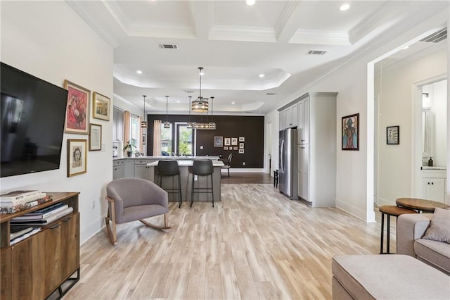 living room featuring ornamental molding and light hardwood / wood-style floors