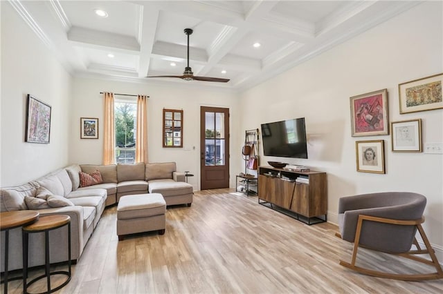 living room featuring ornamental molding, coffered ceiling, light hardwood / wood-style floors, beamed ceiling, and ceiling fan