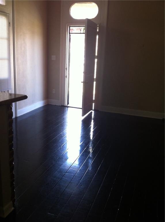 spare room with dark wood-type flooring