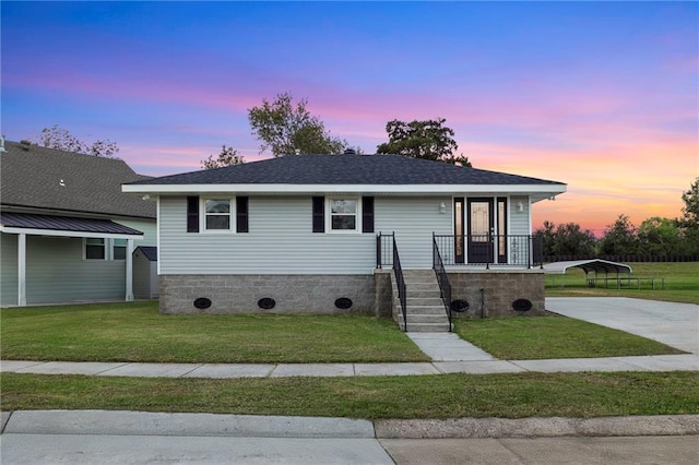 view of front of house with a lawn and a carport