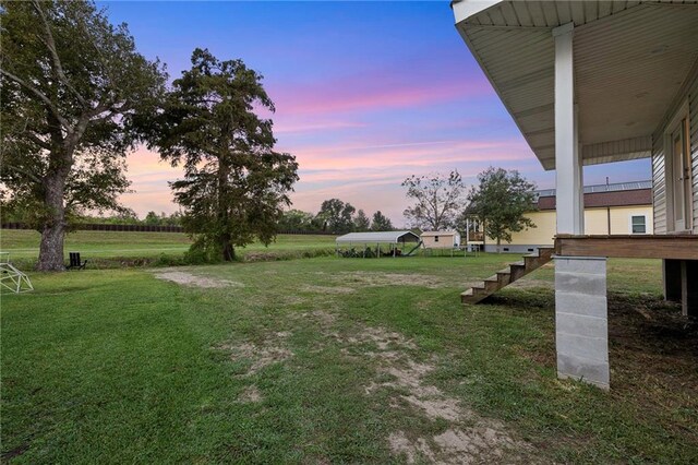 view of yard at dusk