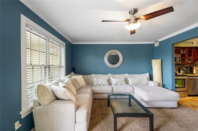 living room featuring ceiling fan and ornamental molding