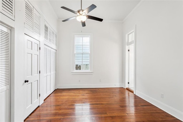 unfurnished bedroom with ornamental molding, hardwood / wood-style floors, and ceiling fan