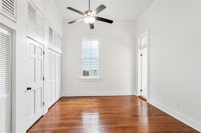 2927 Palmyra St, New Orleans, LA 70119 - unfurnished bedroom featuring multiple windows, hardwood / wood-style floors, baseboards, and crown molding