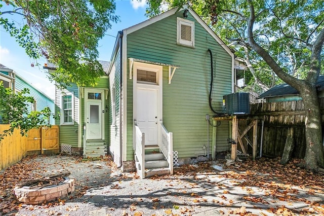 2927 Palmyra St, New Orleans, LA 70119 - rear view of house featuring entry steps, cooling unit, and an outdoor fire pit