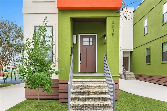 entrance to property with stucco siding