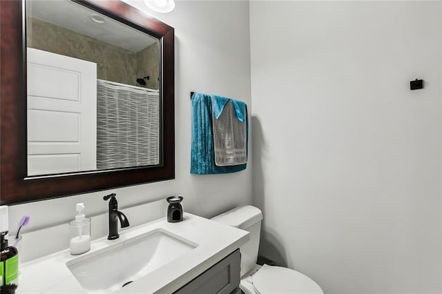 full bathroom featuring vanity, toilet, and walk in shower