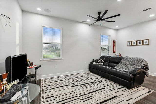 living room with hardwood / wood-style flooring and ceiling fan