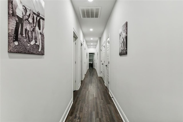 hall with wood finished floors, recessed lighting, baseboards, and visible vents