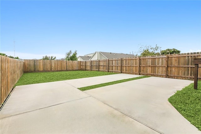 view of yard featuring a patio and a fenced backyard