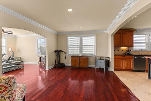 interior space with light hardwood / wood-style flooring, a healthy amount of sunlight, and ornamental molding