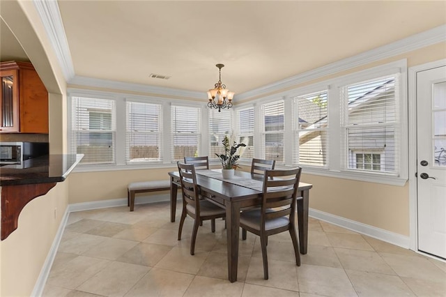 dining room featuring ornamental molding, light tile patterned floors, and an inviting chandelier