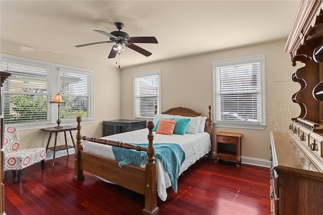 bedroom with multiple windows, dark hardwood / wood-style floors, and ceiling fan