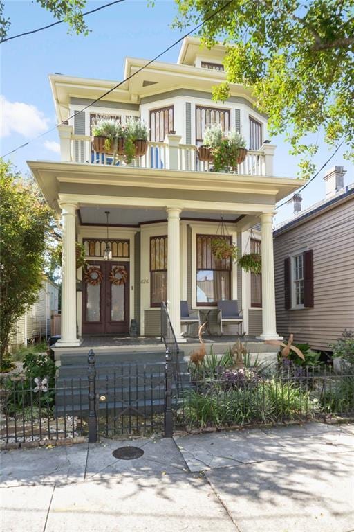 view of front of house with covered porch and a balcony