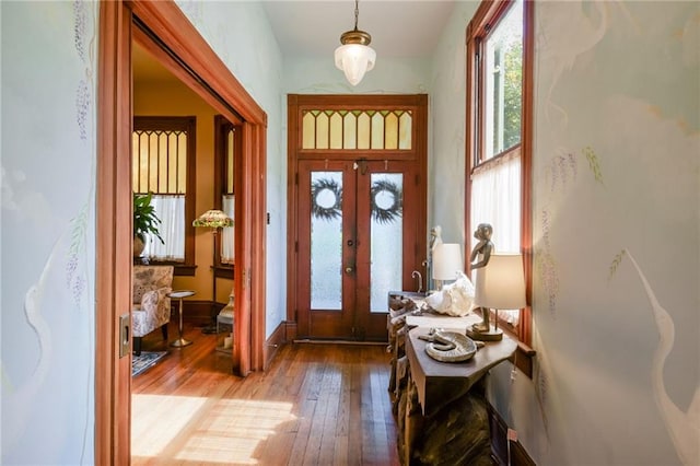 entrance foyer with light hardwood / wood-style floors and french doors