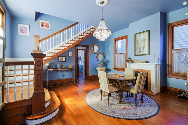 dining room with hardwood / wood-style flooring and a notable chandelier