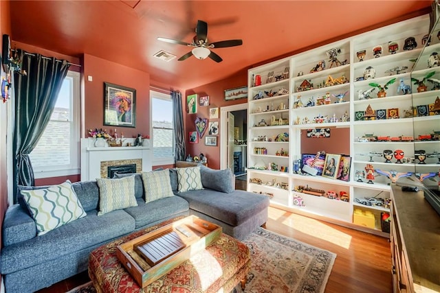 living room featuring hardwood / wood-style floors and ceiling fan