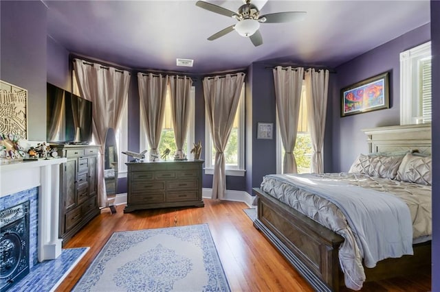 bedroom with light wood-type flooring and ceiling fan