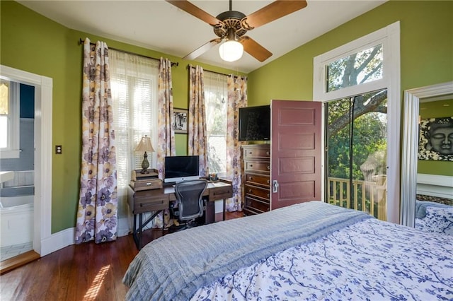 bedroom featuring dark wood-type flooring, access to outside, ceiling fan, and ensuite bath