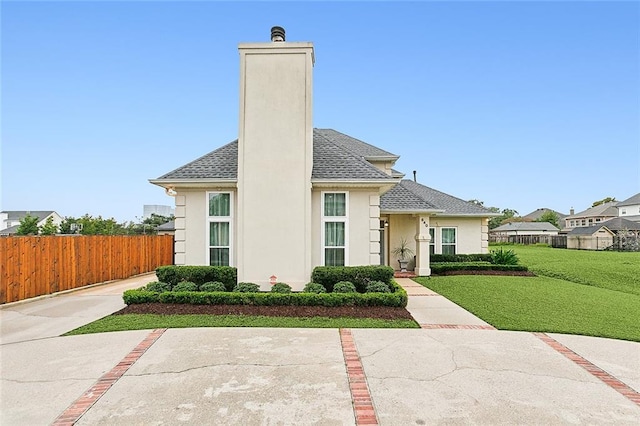 view of front of home featuring a front yard and a patio area