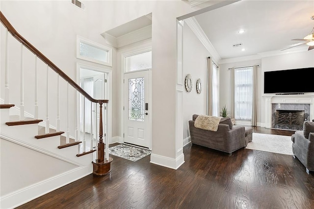 entryway with wood-type flooring and crown molding