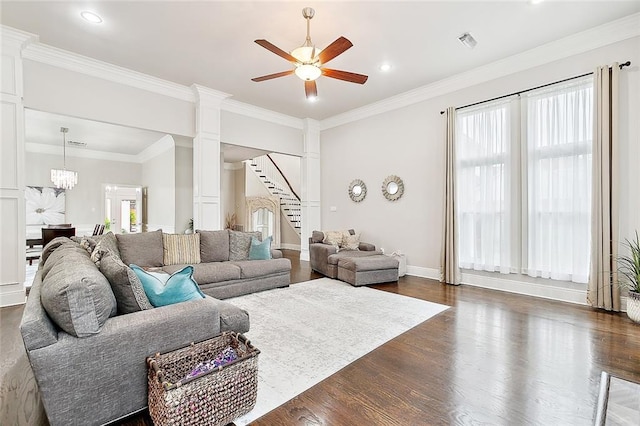 living room featuring dark hardwood / wood-style flooring, crown molding, and plenty of natural light