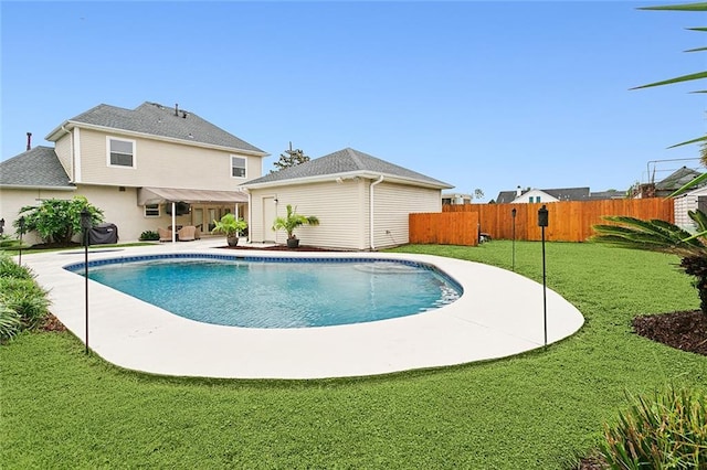 view of swimming pool featuring a yard and a patio area