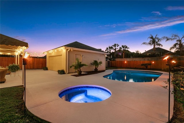 pool at dusk with an outbuilding, a patio, and an in ground hot tub