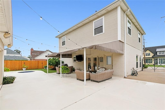 rear view of property featuring outdoor lounge area, a patio, and french doors