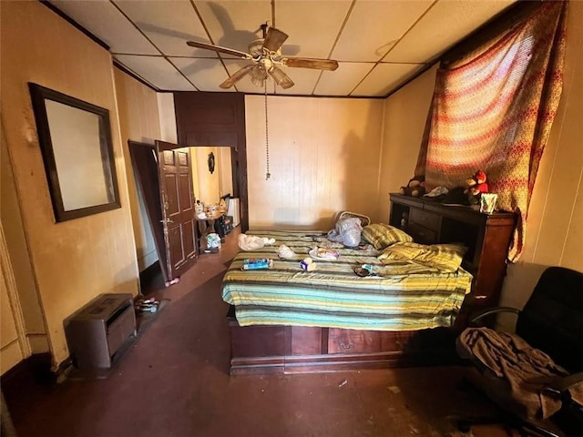 bedroom featuring ceiling fan and a drop ceiling