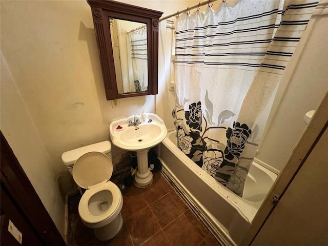 bathroom featuring tile patterned flooring, shower / bath combination with curtain, and toilet