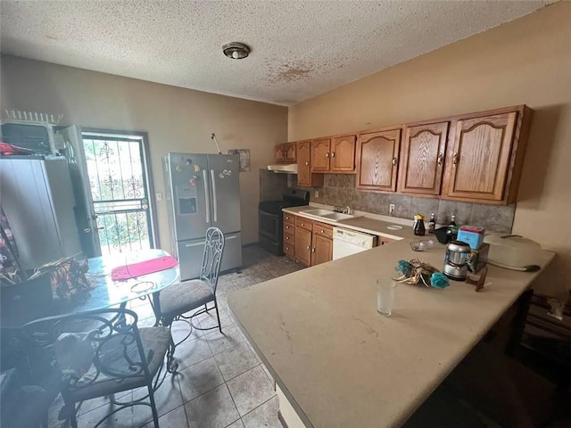 kitchen featuring kitchen peninsula, stainless steel refrigerator with ice dispenser, tasteful backsplash, white dishwasher, and black electric range