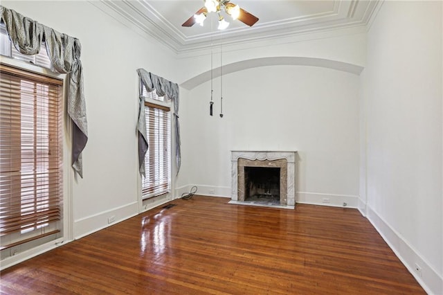 unfurnished living room featuring a high end fireplace, hardwood / wood-style flooring, a wealth of natural light, and ceiling fan