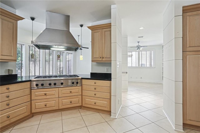 kitchen featuring stainless steel gas stovetop, island range hood, hanging light fixtures, and ceiling fan