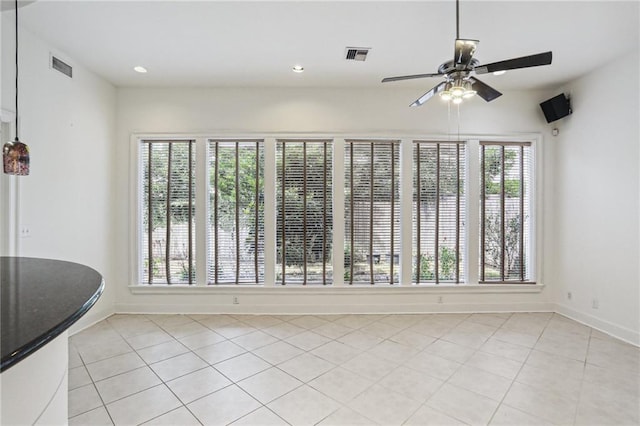 unfurnished room featuring ceiling fan and light tile patterned flooring