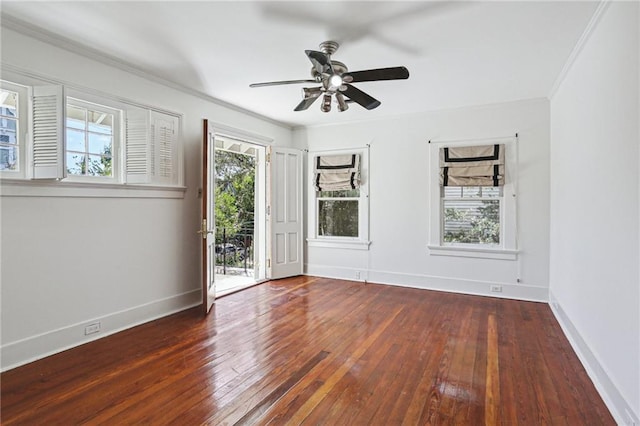 empty room featuring ornamental molding, dark wood-type flooring, and a healthy amount of sunlight