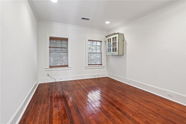 spare room with wood-type flooring and ornamental molding