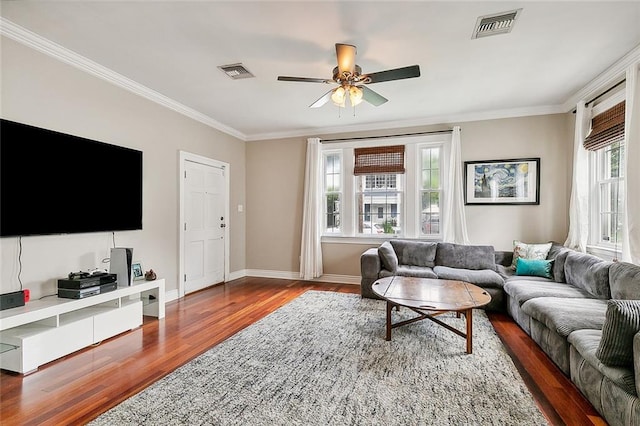 living room with hardwood / wood-style flooring, crown molding, and ceiling fan