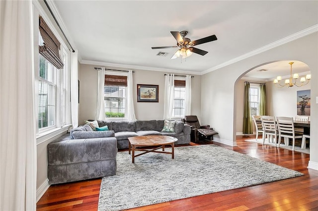 living room with dark hardwood / wood-style floors, ceiling fan with notable chandelier, and ornamental molding