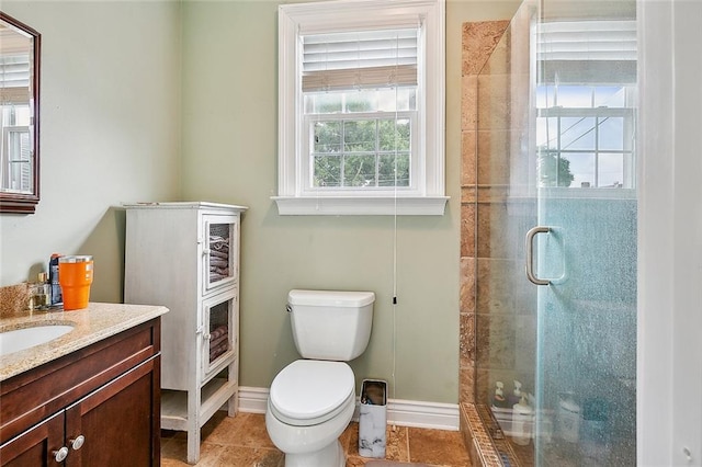 bathroom with tile patterned flooring, vanity, toilet, and a shower with shower door