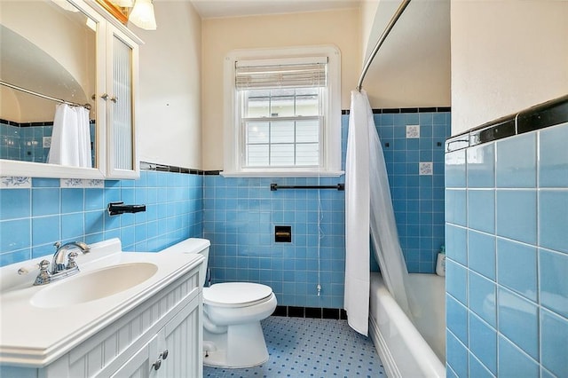 full bathroom featuring toilet, shower / tub combo, tile walls, and vanity