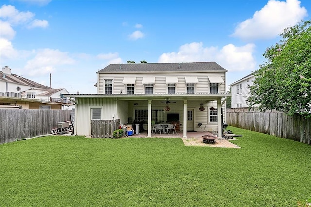 rear view of house with a patio, an outdoor fire pit, and a lawn