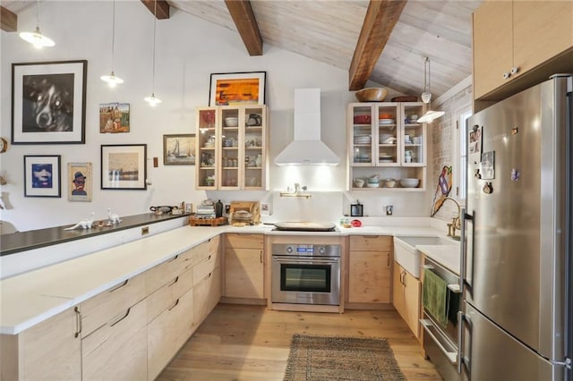 kitchen featuring sink, hanging light fixtures, stainless steel appliances, light brown cabinets, and wall chimney exhaust hood