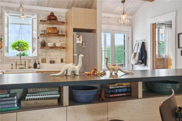 kitchen with premium range hood, light brown cabinetry, and oven