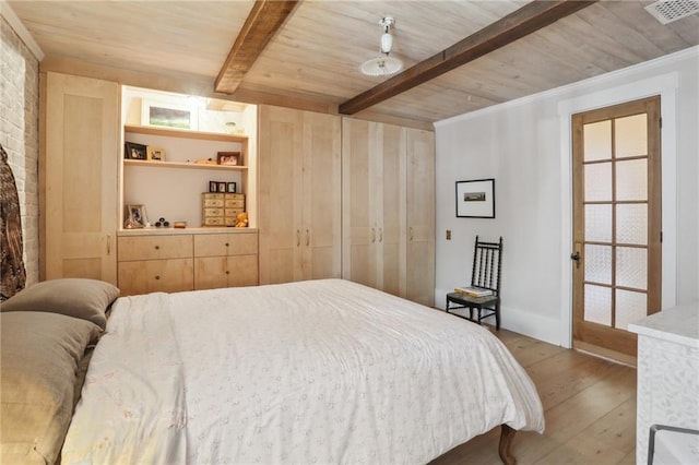 bedroom with wood ceiling, brick wall, beam ceiling, and hardwood / wood-style floors