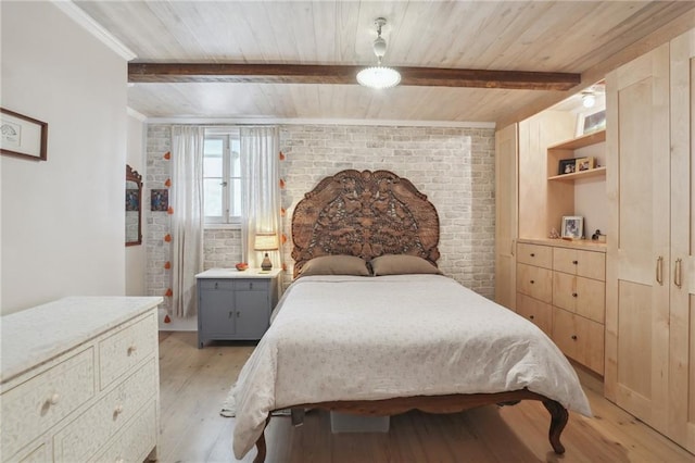 bedroom featuring beamed ceiling, light hardwood / wood-style flooring, wood ceiling, and brick wall