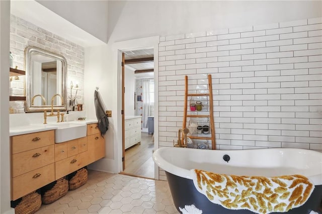 bathroom featuring vanity, tile patterned flooring, and a tub