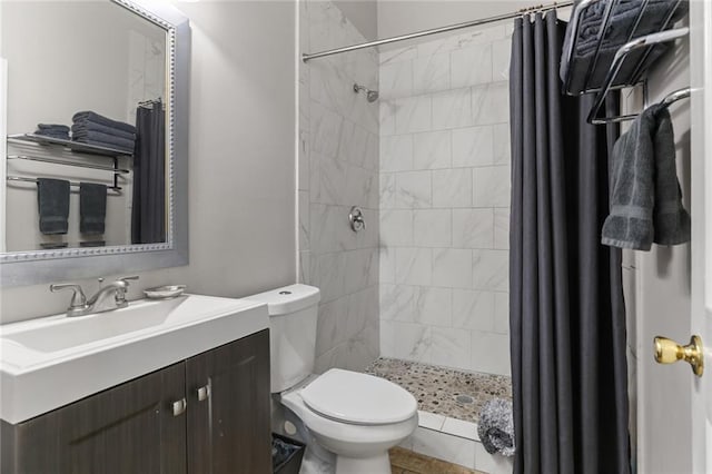 bathroom with a shower with curtain, vanity, toilet, and tile patterned flooring